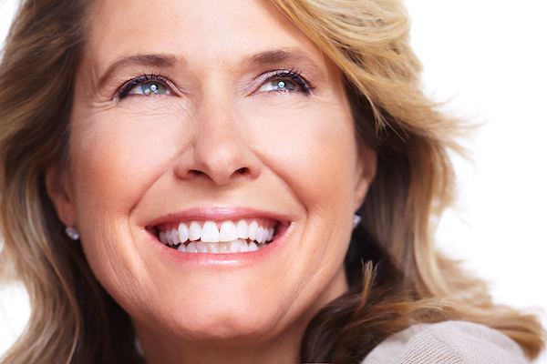 Woman smiling with her dental implant 